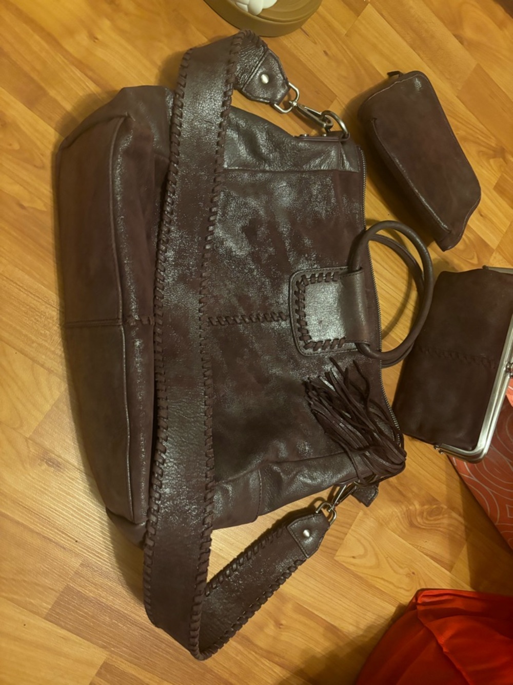 HOBO Dark Purple Leather Crossbody Bag with wallet and makeup bag.
